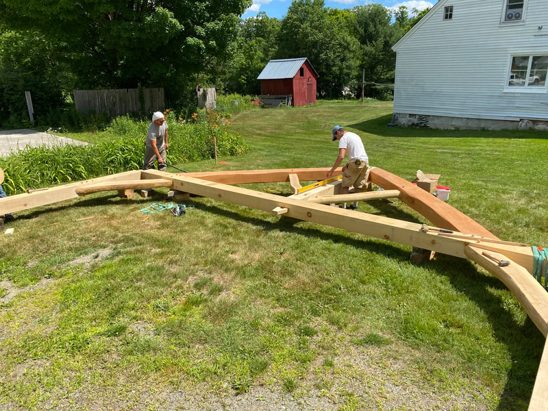 Vermont Natural Homes crew assembling timberframe pavilion 